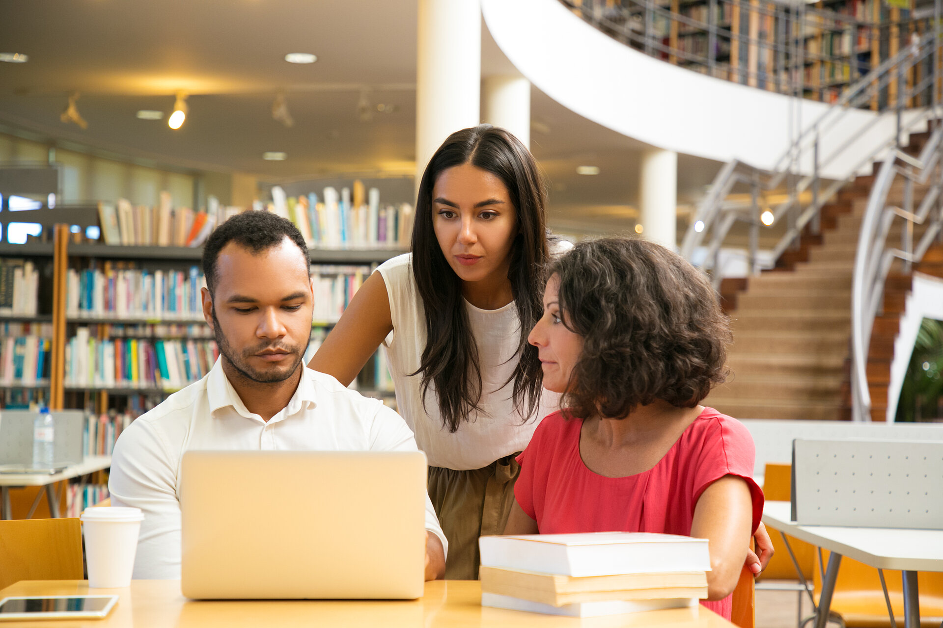 Three students sitting in the library